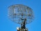 Military directional antenna on a blue sky.