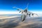 Military fighter jet against a blue sky with a backlight from below.