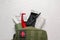Military first aid kit, tourniquet, pills and elastic bandage on white wooden table, flat lay