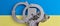 Military handcuffs on blue and yellow background of Ukrainian flag