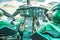 Military helicopter cockpit with two pilots flying over a tropical lake