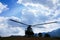 Military helicopter ground running on a mountain peak