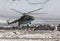 Military helicopter landing on ice of mountain glacier