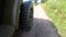 Military jeep  car driving on dirt road, close up of wheel