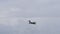 Military jet plane flies straight at high speed in a cloudy sky