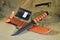 Military knife fixed black steel blade leather sheet brown background