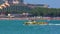 Military landing speed boat with weapons unfolds on blue surface of sea leaving foam traces