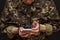 A military man in handcuffs makes a phone call on a dark background, selective focus. Concept: prisoner of war talking on the phon