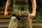 A military man holds a medical tourniquet in his hands to stop blood in first aid and prevent bleeding.