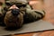 A military man with a Ukrainian flag in a helmet is lying on a carriage. Training in tactical medicine.