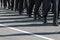 Military marching formation.Shadows on the road.