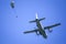 Military paratroopers jump from an Alenia C-27J Spartan military cargo plane