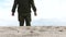 Military patrol in the desert. Movement of the legs in the army gear on the sand in the desert