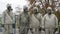 Military personnel in chemical protection suits carry out disinfection, decontamination. Four men in insulating filtering gas mask