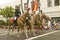 Military personnel on horseback participate at the opening day parade down State Street of Old Spanish Days Fiesta held every