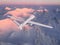 military RC military drone flies against the background of beautiful Arctic ice mountains painted pink by the sunset sun. Elements