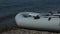A military rubber boat on the beach.