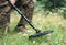 Military sapper with a metal detector in the field. Explosive Ordnance Disposal Officer