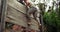 Military soldier climbing a wooden wall at boot camp 4k