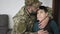 Military soldier kissing his son with disability at home