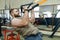 Military sport, muscular caucasian bearded adult man doing exercises in the gym dressed in bulletproof armored vest