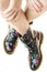 Military style boots with flowers decoration on an hands with po