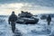 Military Tank and Soldiers in Snowy Terrain.