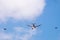 Military tanker aircraft refueler and fighter jets fly on blue sky