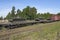 A military train with T-72B3 tanks stands in a railway dead end