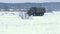 Military truck crosses a snowy field