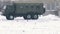 Military truck crosses a snowy field