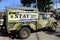 Military truck with a signage of Stay Home Save Lives parked along a sidewalk during the Covid 19 virus outbreak
