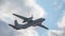 Military twin-engine transport aircraft on sky background