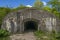 Military underground concrete beton tunnel entrance. Dark hole of subterranean grotto exit