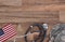 Military and Veterans Health Care Concept. Dog tags, American Flag, military camo hat and stethoscope on a wood background