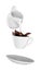 Milk being poured into small cup of coffee. white background