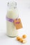 Milk bottle with label and inscription Milk and milk candies on white background