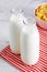 Milk bottles and cereal corn flakes on wooden table