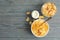 Milk, bowl and jar of muesli on wooden  background