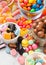 Milk chocolate candies woth shell in jar with various jelly gums candies on white background with liquorice allsorts and