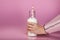 Milk cocktail in glass jar with paper straw in girl`s hands close up