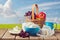 Milk, cottage cheese, butter and fruit basket over meadow background. Jewish holiday Shavuot celebration