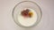 Milk with egg sprinkled with mixture pepper closeup. Slow motion