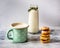 Milk in an enamel mug with peas and a slide of homemade cookies close-up