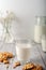 Milk with freshly baked homemade cookies with peanuts on a light background