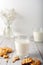 Milk with freshly baked homemade cookies with peanuts on a light background