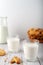 Milk with freshly baked homemade cookies with peanuts on a light background