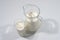 Milk in a glass with a jug on a gray background. Side view. Milk product