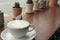 The Milk green tea latte in cup with cactus  on wood table background