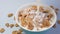 Milk pouring into bowl with bran flakes, healthy cereal breakfast